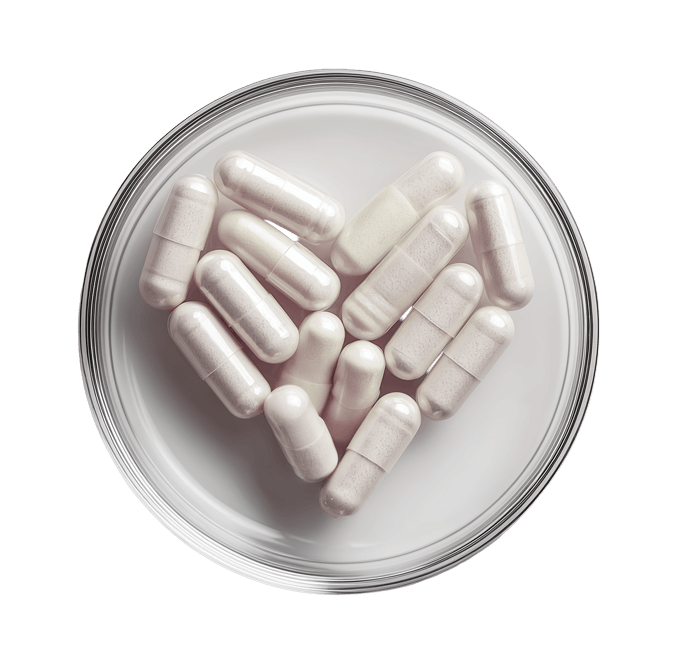 Draufsicht von Supplement-Kapseln in Petrischale, herzförmig angeordnet. KI-generiert